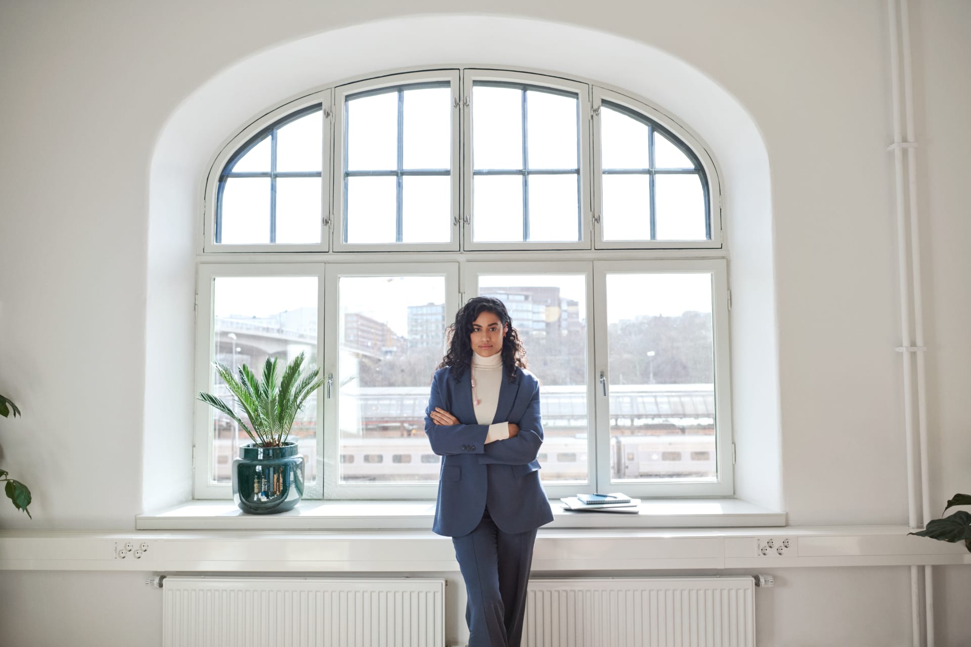 Woman standing in front of large window